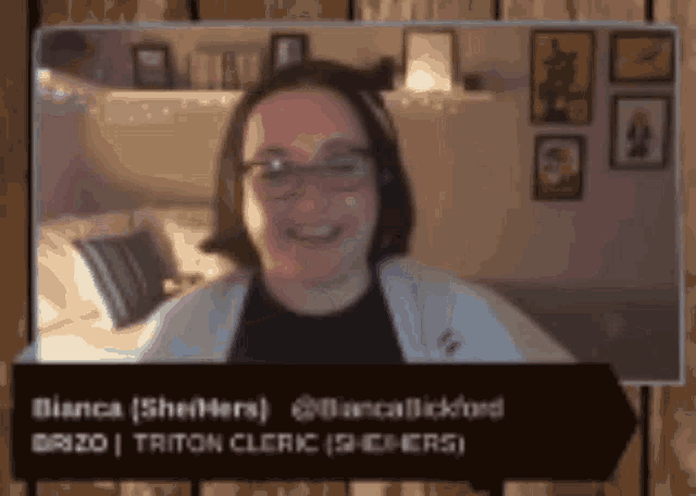 a woman wearing glasses is smiling in front of a sign that says bianca