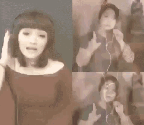a woman wearing headphones is singing into a microphone while making a peace sign .