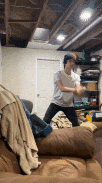 a man is playing a video game in a living room .