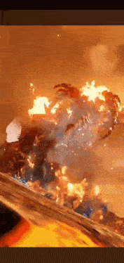 a person is standing in front of a fire that is coming out of the ground .