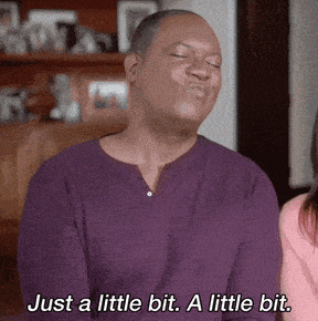 a man in a purple shirt is making a face and saying just a little bit a little bit