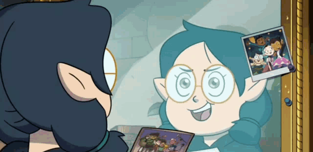 a cartoon character is looking at herself in a mirror while holding a picture of herself .