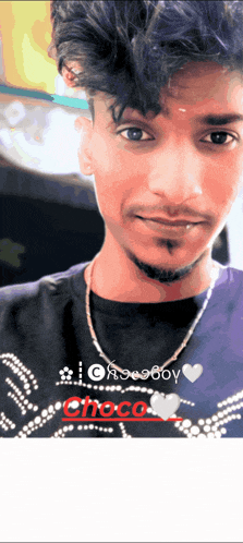 a young man wearing a purple shirt that says choco boy