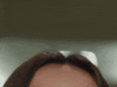 a close up of a woman 's eye with a yellow sticker on it