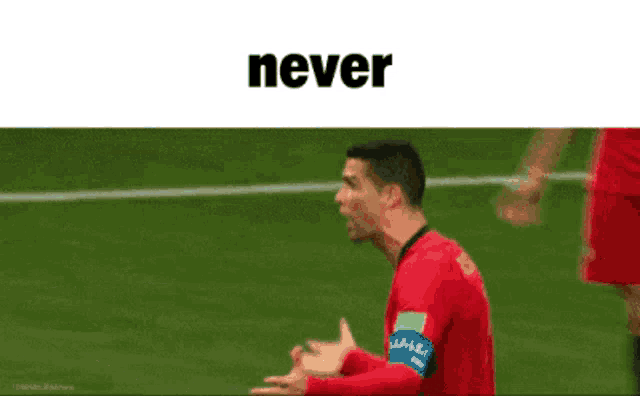 a soccer player is talking to another player and the word never is above him