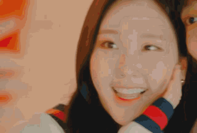 a close up of a woman 's face with a striped sweater on