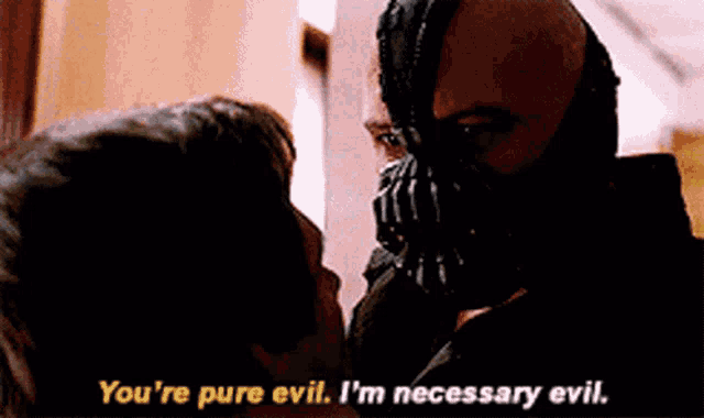 a man in a mask is talking to another man who is wearing a mask .