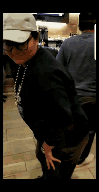 a woman wearing a white hat and a black shirt with the word snoop dogg on the front