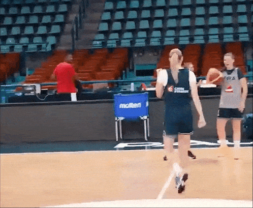 a basketball player wearing a jersey that says ' france ' on it dribbles the ball