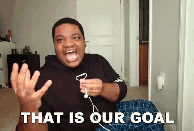 a man wearing headphones screams that is our goal in front of a door