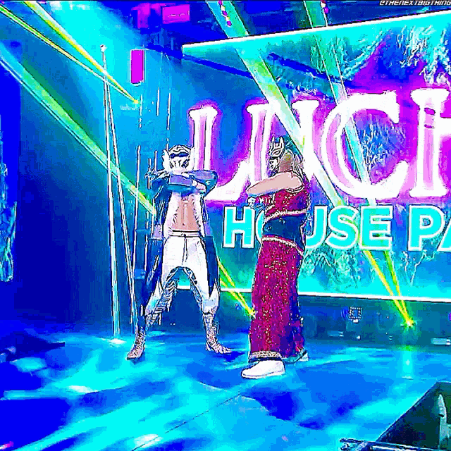 two wrestlers on a stage in front of a banner that says lunch house