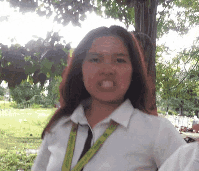 a woman in a white shirt with a yellow lanyard around her neck that says ' columbia '