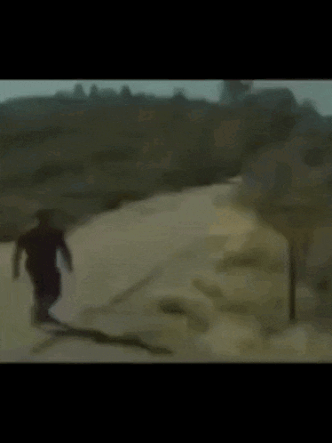 a blurred image of a man walking down a road