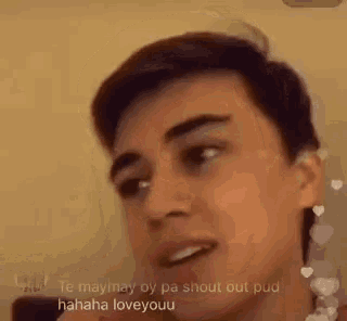 a young man is making a funny face while talking on a video .