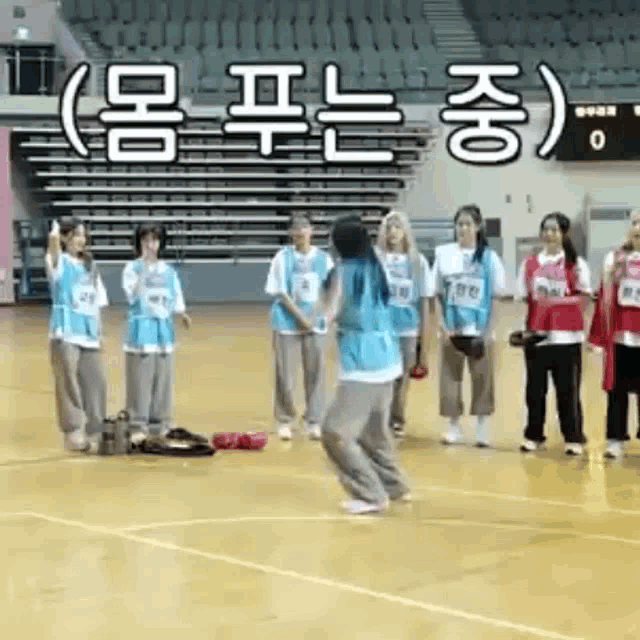 a group of women are playing basketball on a court .