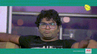 a man wearing glasses and a black shirt with the word ae on it