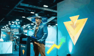 a man stands at a podium with a laptop in front of a sign that says " loyalty "