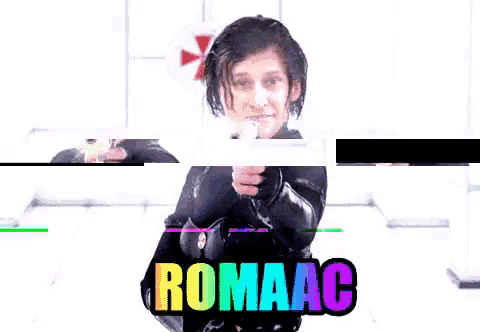 a woman is pointing a gun at the camera and the word romaac is on the bottom right