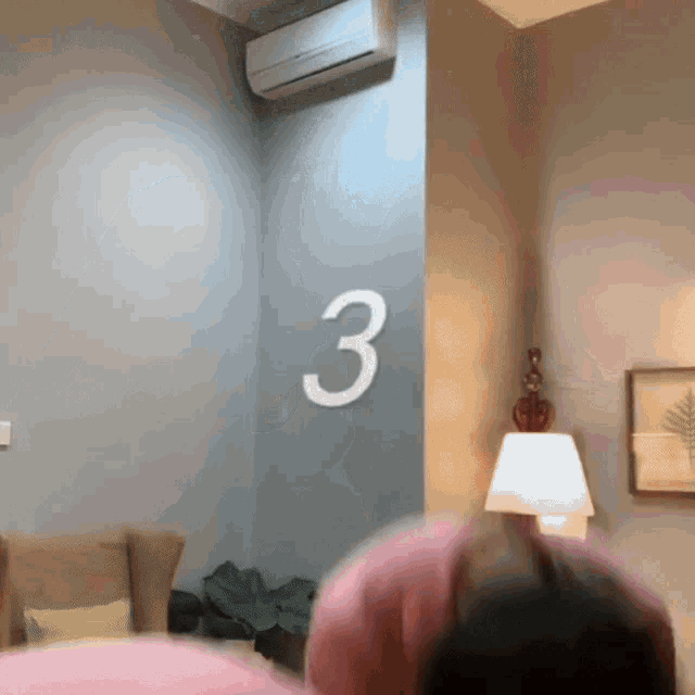 a room with a gray wall and the number 3 on it