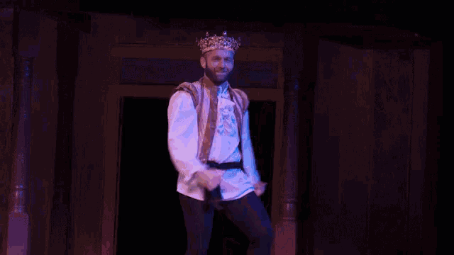 a man wearing a crown jumps in the air