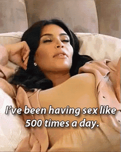 a woman is laying on a bed and says i 've been having sex like 500 times a day .