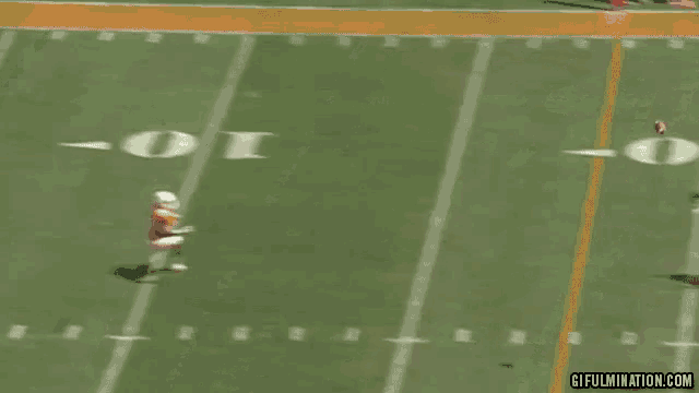 a football player is laying on his back on the field