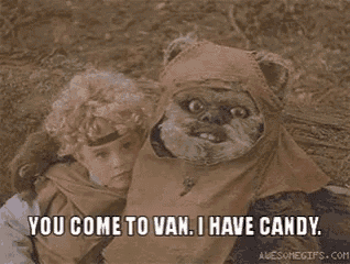 a child is holding a stuffed animal that looks like ewok from star wars and they are talking about candy .