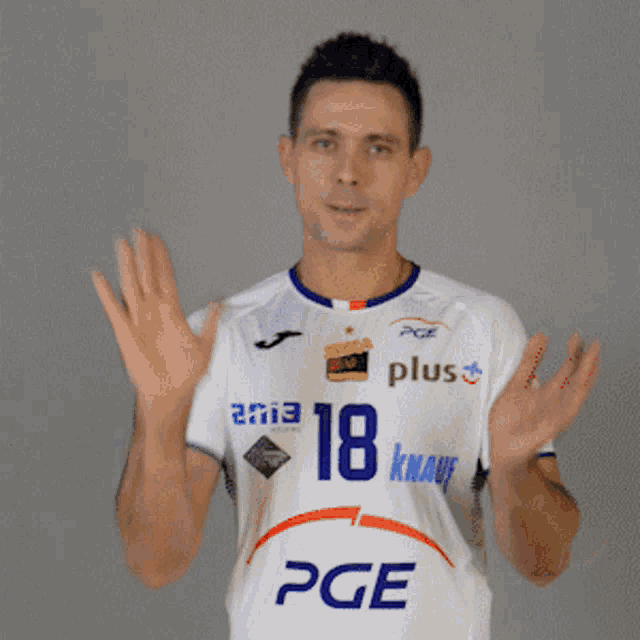 a man wearing a white pge plus shirt