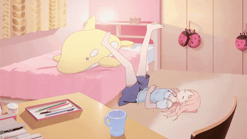 a girl laying on a bed with her legs up and a ladybug hanging on the wall