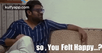 a man is sitting on a couch wearing sunglasses and a striped shirt and says `` so , you felt happy ? ''