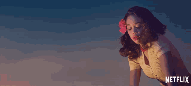 a woman with a flower in her hair and the word netflix in the corner