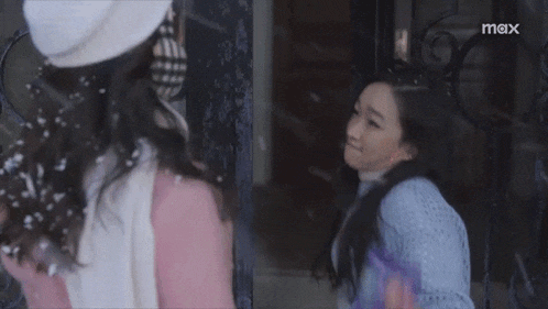 two women are hugging each other in front of a sign that says mex