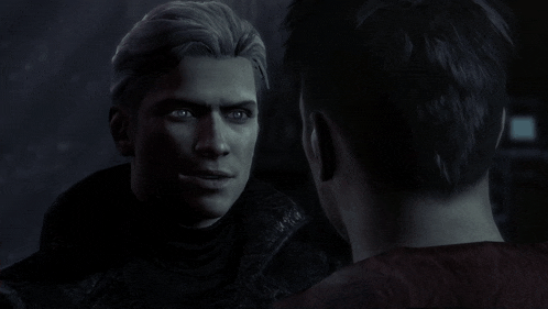 a man with gray hair is talking to another man in the dark