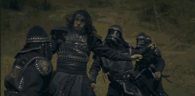 a man with a sword is fighting another man with a spear