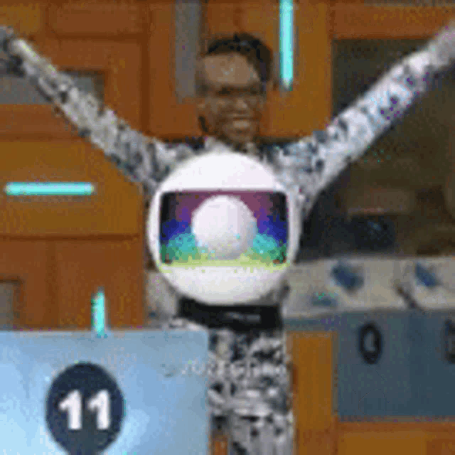 a man with his arms outstretched is holding a globe with the number 11 on it
