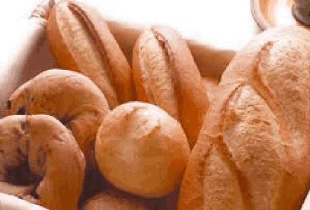 a basket filled with a variety of breads and pastries .