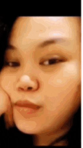 a close up of a woman 's face with a blurred background .