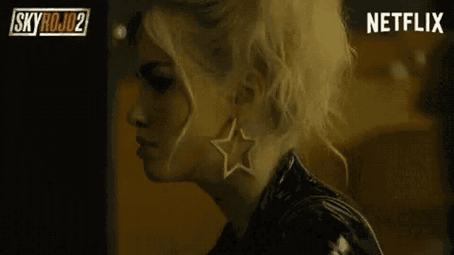 a close up of a woman 's face with a netflix logo behind her .