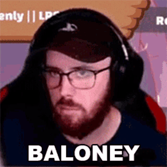 a man with a beard and glasses is wearing headphones and a hat and has the word baloney on his face .