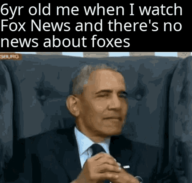 a man in a suit and tie is sitting in a chair watching fox news .