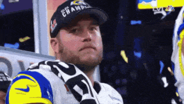 a man wearing a hat with the word champions on it