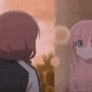 a couple of anime girls are standing next to each other .