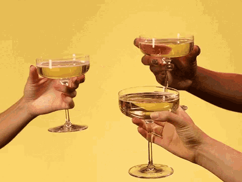 a group of people toasting with champagne glasses on a yellow background