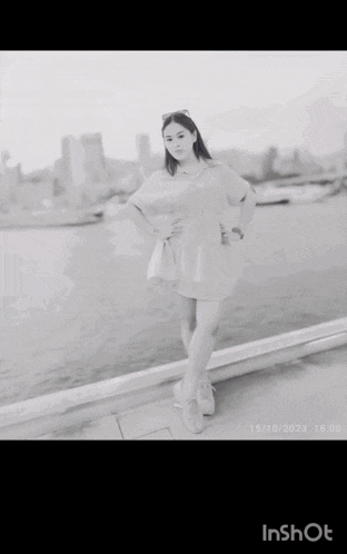 a black and white photo of a woman in a dress