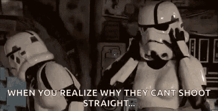 a couple of stormtroopers are standing next to each other in a room and talking to each other .