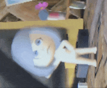 a blurred image of a doll with a blue head