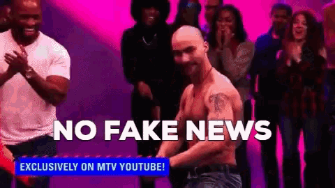 a man without a shirt is dancing in front of a crowd with the words " no fake news " behind him