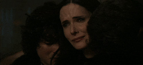 a woman is crying while another woman looks on