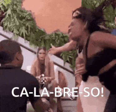 a woman is standing in front of a group of people with the words ca-la-bre-so on the bottom