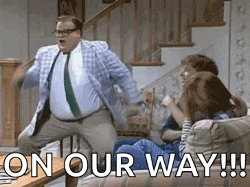 a man in a suit and tie is dancing in front of a group of people .